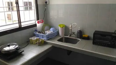 a kitchen counter with a sink and a window at J&P Homestays House 1 in Kampar