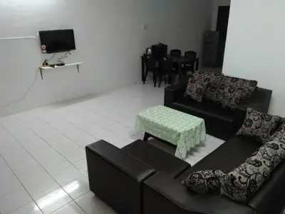 a living room with two couches and a table at J&P Homestays House 1 in Kampar