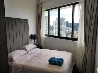 a bedroom with a bed and a large window at The Landmark in George Town