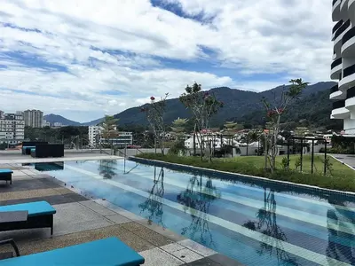 a large swimming pool with a view of a city at The Landmark in George Town