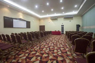 a conference room with chairs and a projection screen at Hotel Seri Malaysia Ipoh in Ipoh