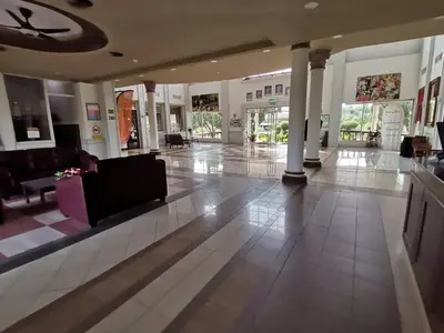 a lobby with a couch and chairs in a building at Hotel Seri Malaysia Kulim in Kulim