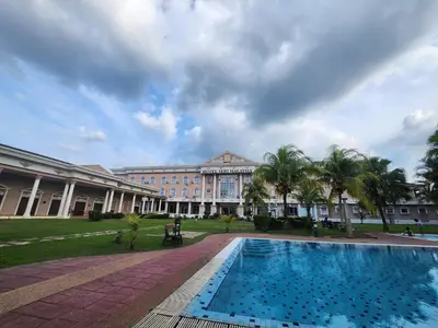 a large building with a swimming pool in front of it at Hotel Seri Malaysia Kulim in Kulim