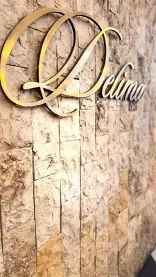 a close up of a sign on a stone wall at Hotel Seri Malaysia Kepala Batas in Kepala Batas