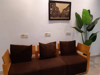 a couch in a room with a picture on the wall at Hotel Seri Malaysia Pulau Pinang in Bayan Lepas