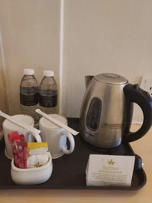 a counter with a coffee pot and cups on it at Hotel Seri Malaysia Pulau Pinang in Bayan Lepas