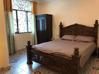 a large bed in a bedroom with a large window at Golden Hill in Cameron Highlands
