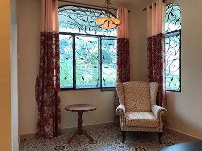 a room with a chair and a window at Golden Hill in Cameron Highlands