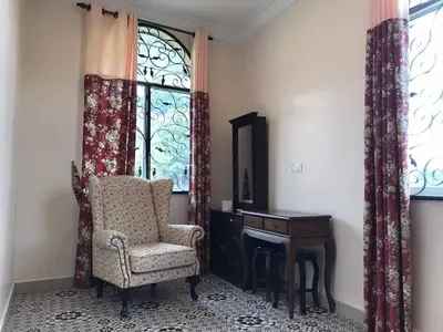 a room with a chair and a desk and a window at Golden Hill in Cameron Highlands