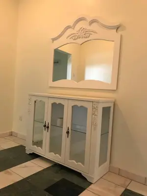 a white cabinet with glass doors and a mirror at Golden Hill in Cameron Highlands