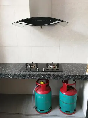 a kitchen with two fire hydrants under a stove at Golden Hill in Cameron Highlands