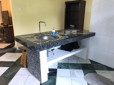 a granite counter top with a sink in a room at Golden Hill in Cameron Highlands