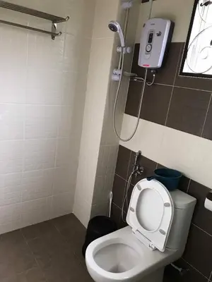 a bathroom with a toilet and a shower at Golden Hill in Cameron Highlands