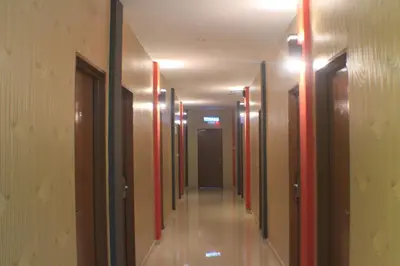 a hallway of a building with a long corridor at Pz Hotel in Kuala Kangsar