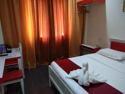 a hotel room with a bed with a towel on it at Pz Hotel in Kuala Kangsar