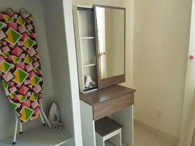 a bathroom with a mirror and a dressing table at Leezahomestay in Bayan Lepas