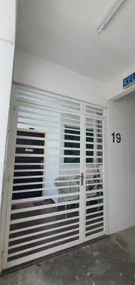 a room with a garage door with a number sixteen at Leezahomestay in Bayan Lepas