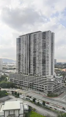 a large apartment building with a highway in front of it at Leezahomestay in Bayan Lepas