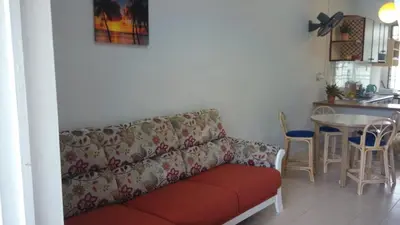 a living room with a couch and a table at Pinang Beach Apartment @ Bayu Emas in Batu Ferringhi