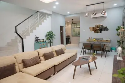 a living room with a couch and a table at De Nest Holiday home in Bayan Lepas