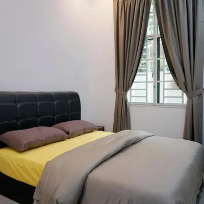 a bedroom with a bed and a window at De Nest Holiday home in Bayan Lepas
