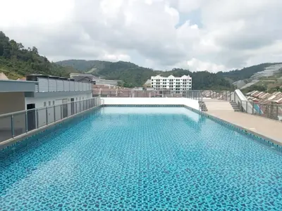 a large swimming pool on the roof of a building at Sekata Apartment in Cameron Highlands