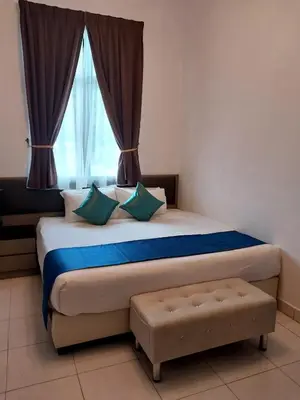 a bedroom with a large bed with a window at Sekata Apartment in Cameron Highlands