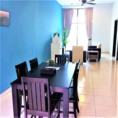 a dining table and chairs in a living room at Sekata Apartment in Cameron Highlands