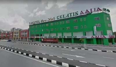 a green building on the side of a road at T-Hotel Ipoh in Ipoh
