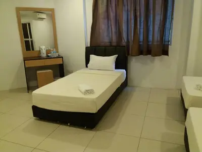 a small bed in a room with a window at T-Hotel Ipoh in Ipoh
