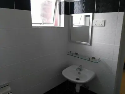a white bathroom with a sink and a mirror at T-Hotel Ipoh in Ipoh