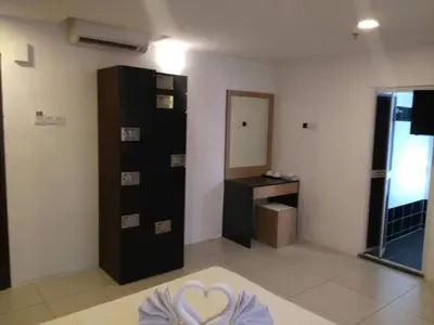 a room with a bathroom with a sink and a mirror at T-Hotel Ipoh in Ipoh