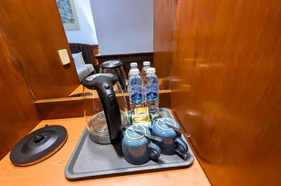 a tray with a coffee maker and bottles of water at Park Avenue Hotel Sungai Petani in Sungai Petani