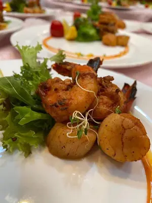 a plate of food with meat and vegetables on a table at Park Avenue Hotel Sungai Petani in Sungai Petani