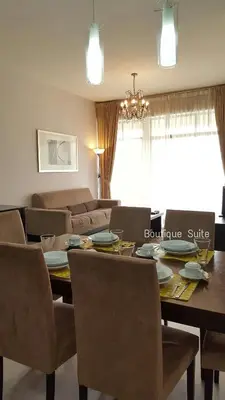 a dining room and living room with a table and chairs at City Tropical Home I in George Town