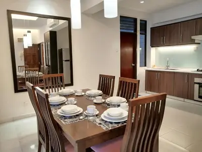 a dining room table with chairs and plates on it at City Tropical Home I in George Town