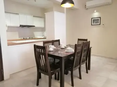 a dining room with a table and four chairs at City Tropical Home I in George Town