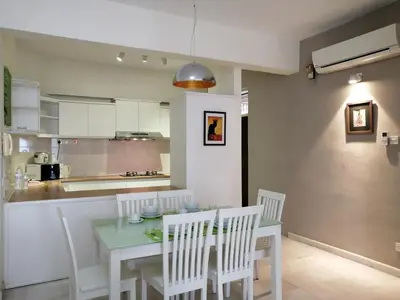 a kitchen and dining room with a table and chairs at City Tropical Home I in George Town