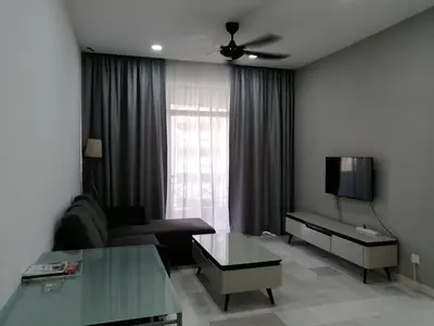 a living room with a couch and a tv at City Tropical Home I in George Town