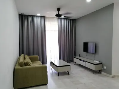 a living room with a couch and a tv at City Tropical Home I in George Town