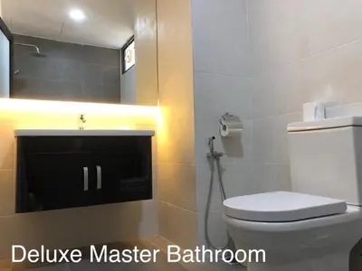 a bathroom with a toilet and a sink at City Tropical Home I in George Town