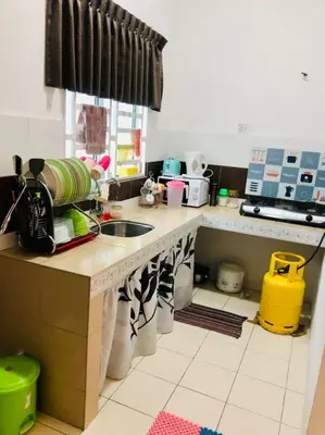a kitchen with a sink and a counter top at Homestay Cahaya 1 Seri Iskandar in Seri Iskandar