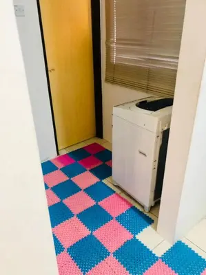 a bathroom with a pink and blue checkered floor at Homestay Cahaya 1 Seri Iskandar in Seri Iskandar