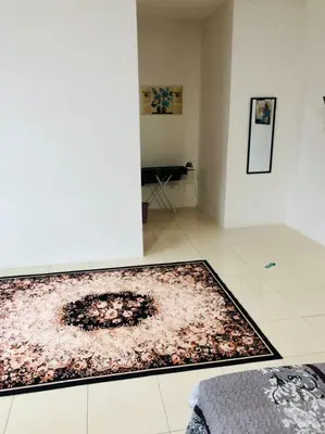 a living room with a rug on the floor at Homestay Cahaya 1 Seri Iskandar in Seri Iskandar