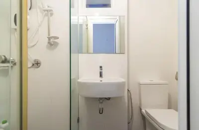 a bathroom with a sink and a mirror and a toilet at Maritime Suite Holiday Rental II in George Town