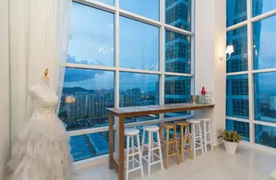 a wedding dress in a room with a large window at Maritime Suite Holiday Rental II in George Town