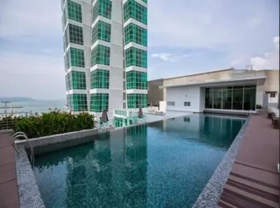 a building with a swimming pool in front of a building at Maritime Suite Holiday Rental II in George Town