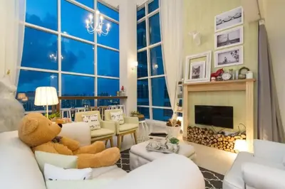 a living room with a teddy bear sitting on a couch at Maritime Suite Holiday Rental II in George Town