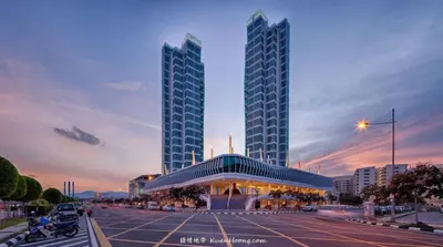 a parking lot with two tall buildings in a city at Maritime Suite Holiday Rental II in George Town