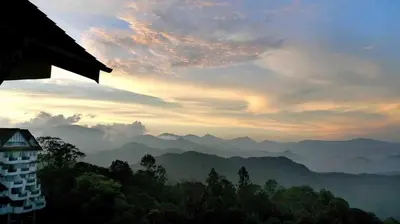 a view of the mountains with a building in the foreground at FH Comfy Home in Bukit Fraser